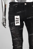 Black patchwork damaged boot cut jeans