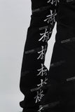 Character embroidered black stacked jeans