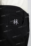 Character embroidered black stacked jeans