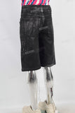 Black waxed patchwork shorts