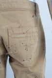 Yellow paint splatters stack jeans